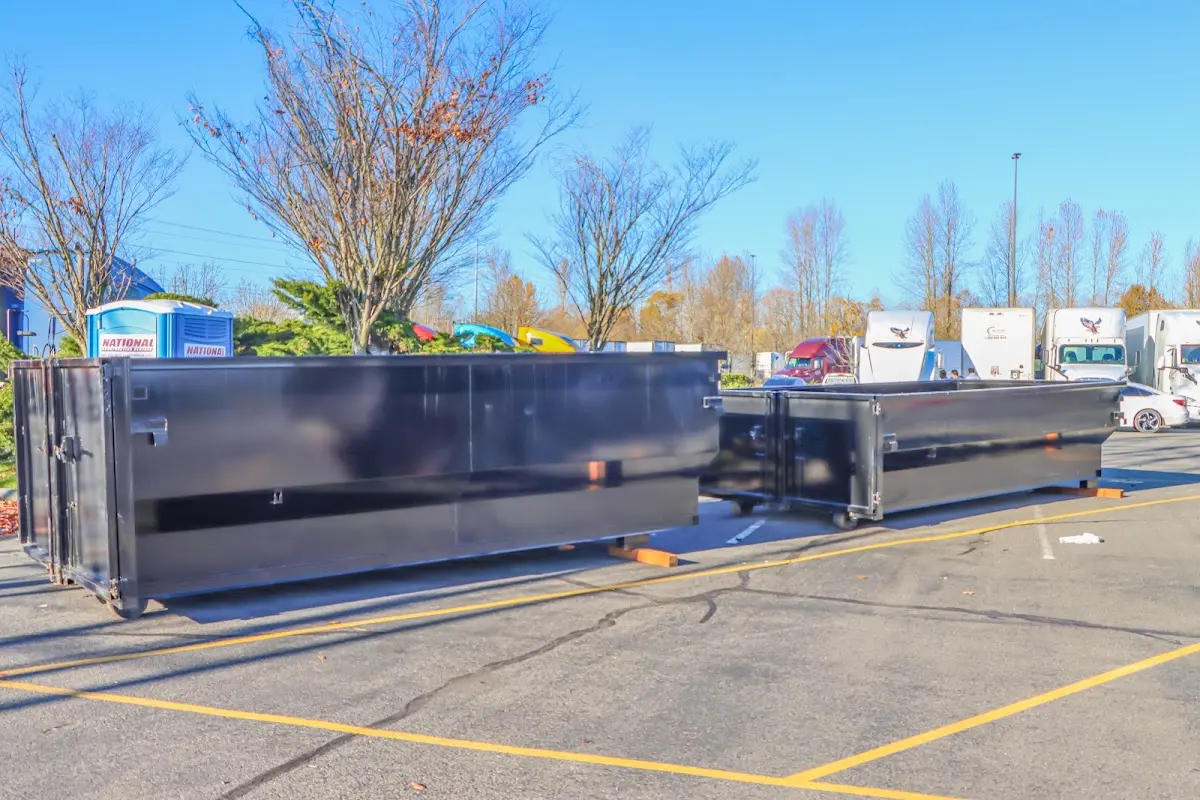 Professional dumpster rental service with roll-off container on residential driveway in White Center
